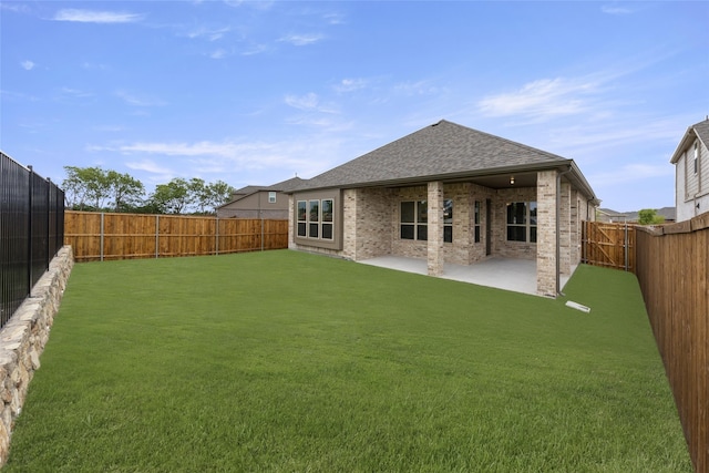 back of property featuring a yard and a patio