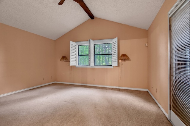 unfurnished room featuring a textured ceiling, vaulted ceiling with beams, ceiling fan, and carpet flooring