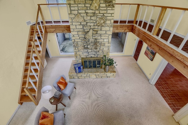 unfurnished living room featuring plenty of natural light, carpet flooring, and a fireplace