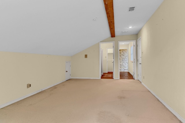 additional living space with lofted ceiling with beams and carpet flooring