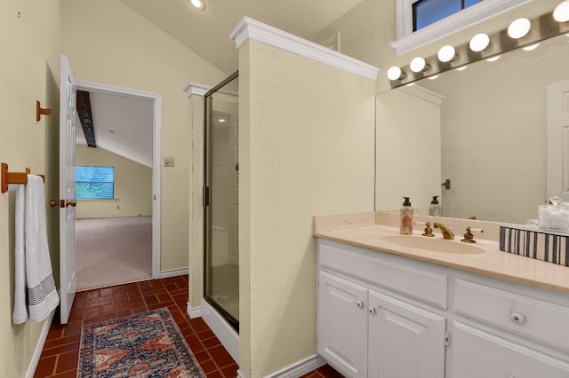 bathroom featuring lofted ceiling, a shower with shower door, and vanity