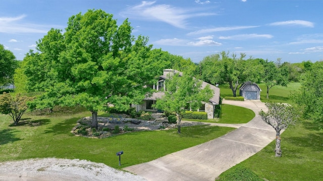 view of home's community with a yard and an outbuilding