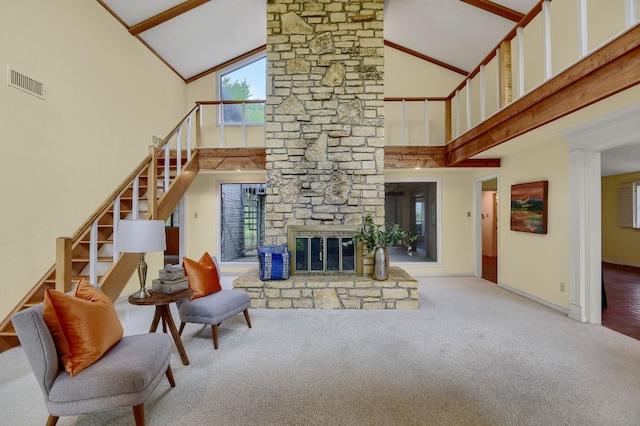 living room with carpet, high vaulted ceiling, and a stone fireplace