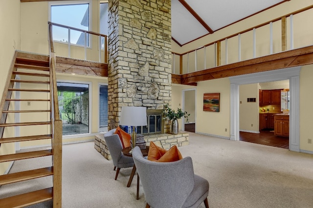 carpeted living room with high vaulted ceiling and a stone fireplace