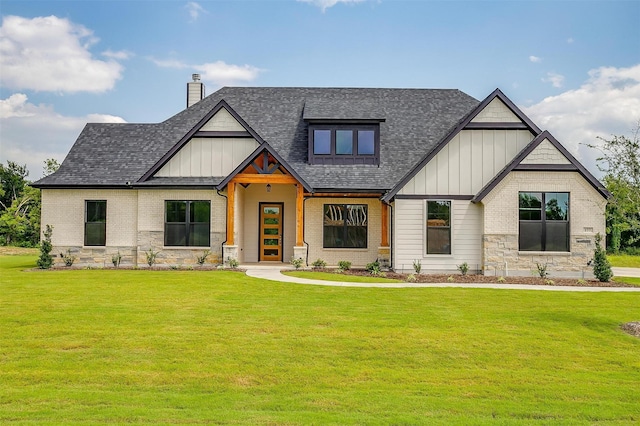 modern inspired farmhouse with roof with shingles, board and batten siding, a chimney, and a front yard