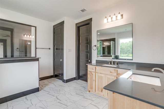 bathroom with vanity, visible vents, baseboards, marble finish floor, and a closet