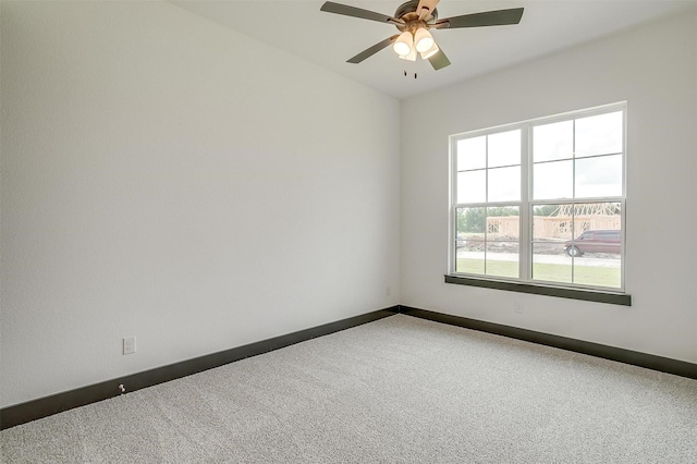 spare room featuring carpet floors, baseboards, and a ceiling fan