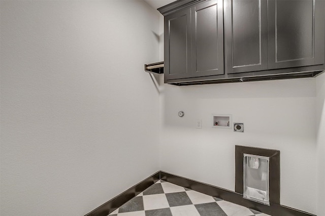 laundry room with hookup for a washing machine, baseboards, cabinet space, tile patterned floors, and electric dryer hookup