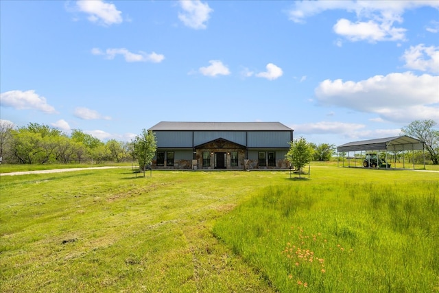 rear view of house with a yard and an outdoor structure