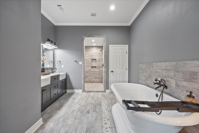 bathroom featuring hardwood / wood-style floors, vanity, separate shower and tub, and ornamental molding