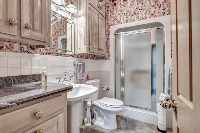 bathroom featuring tile walls, a shower with shower door, toilet, tasteful backsplash, and tile floors