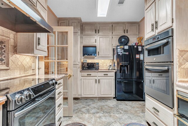 kitchen with appliances with stainless steel finishes, backsplash, light tile floors, and light stone countertops