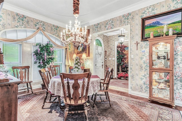 dining room with wood-type flooring, plenty of natural light, a notable chandelier, and crown molding