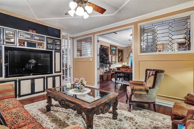 kitchen featuring wall chimney exhaust hood, black fridge, range with electric stovetop, tasteful backsplash, and stainless steel double oven