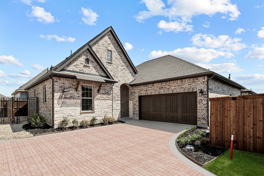 french country home with a garage