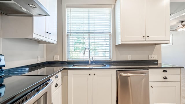 kitchen with sink, ceiling fan, dark stone countertops, stainless steel appliances, and white cabinets