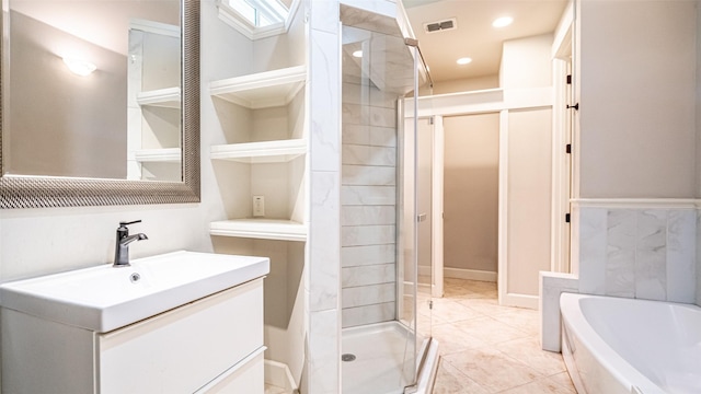 bathroom with vanity, independent shower and bath, and tile patterned flooring