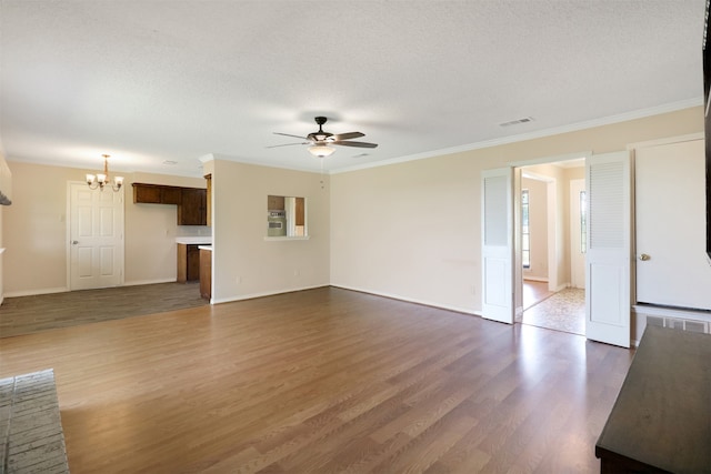 unfurnished living room with ornamental molding, wood-type flooring, ceiling fan with notable chandelier, and a textured ceiling