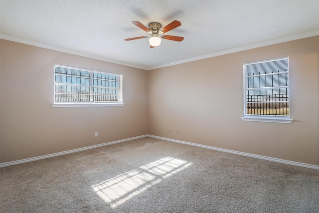 carpeted empty room with ceiling fan, crown molding, and a textured ceiling