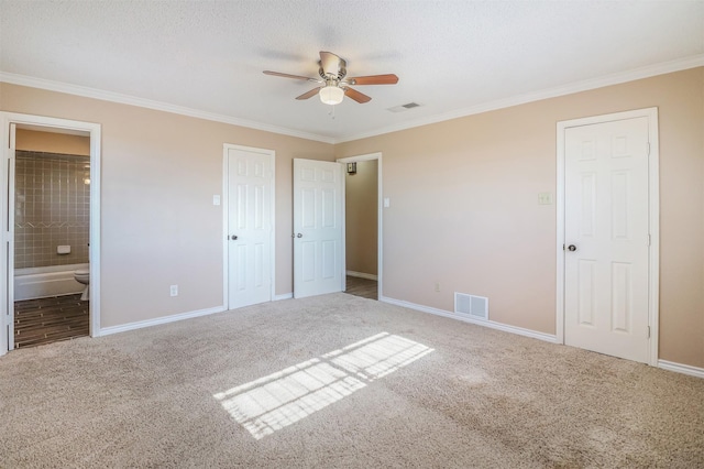 unfurnished bedroom featuring ornamental molding, carpet, and ensuite bathroom