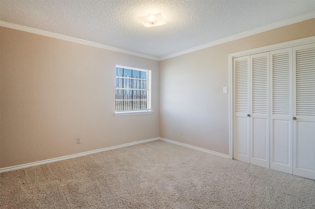 unfurnished bedroom with crown molding, carpet flooring, a closet, and a textured ceiling