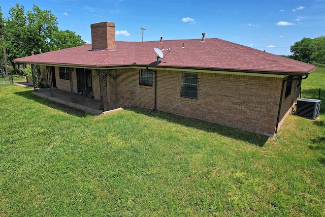 back of house featuring a patio, a yard, and central AC