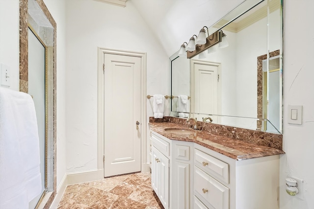 bathroom with lofted ceiling, vanity, and tile patterned floors