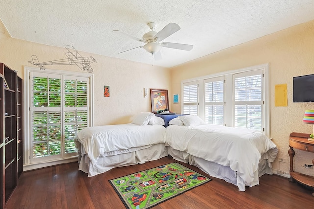 bedroom with ceiling fan, dark wood-type flooring, and multiple windows