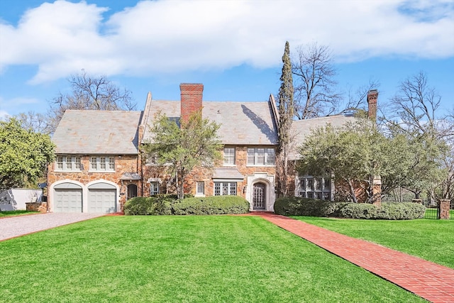 tudor house with a garage and a front yard