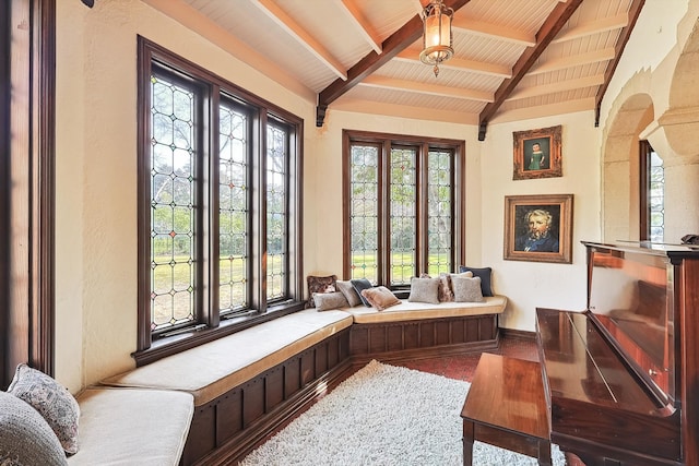 interior space featuring vaulted ceiling with beams and wooden ceiling