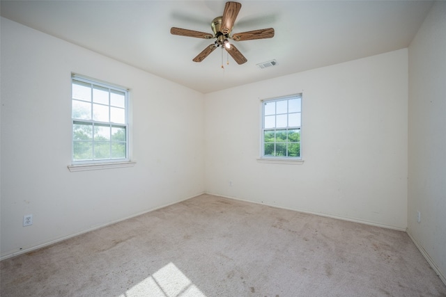 carpeted empty room featuring ceiling fan