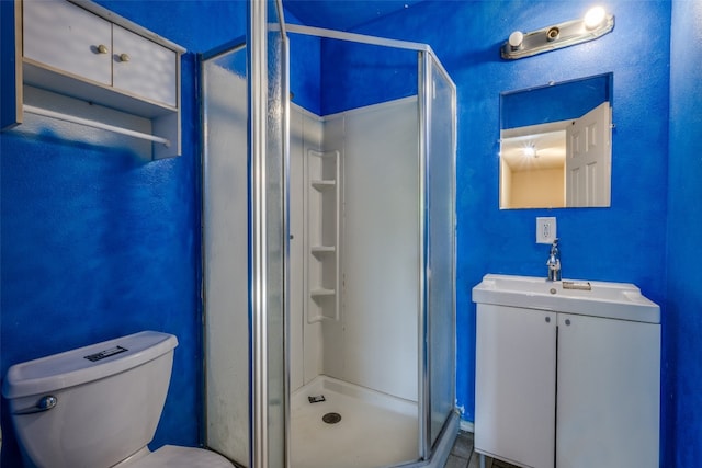 bathroom with vanity, toilet, and walk in shower