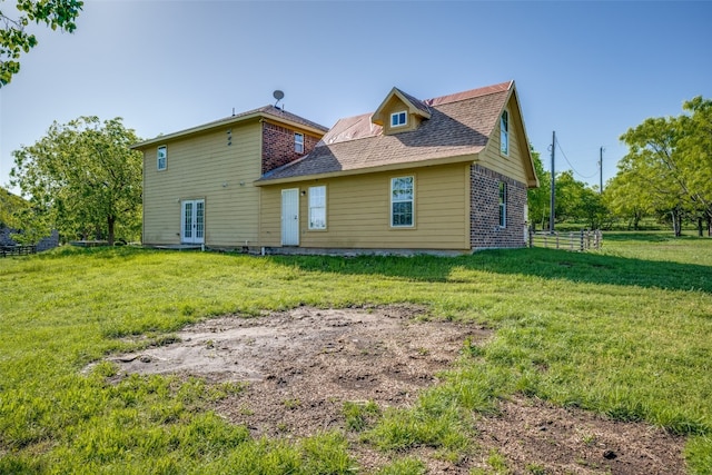 back of property featuring a lawn