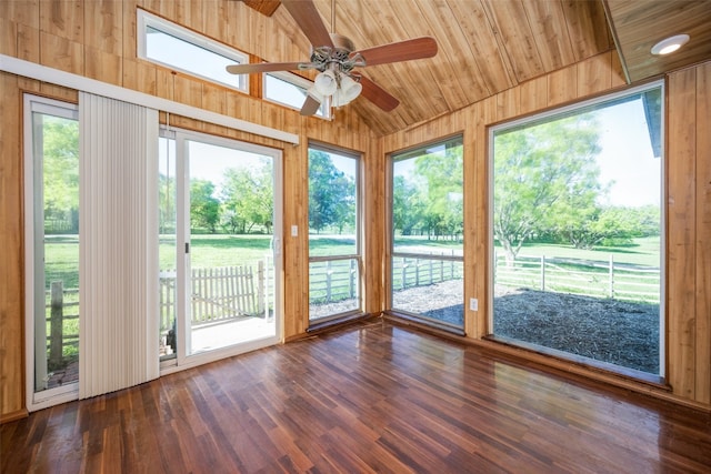 unfurnished sunroom featuring ceiling fan, a healthy amount of sunlight, wood ceiling, and vaulted ceiling