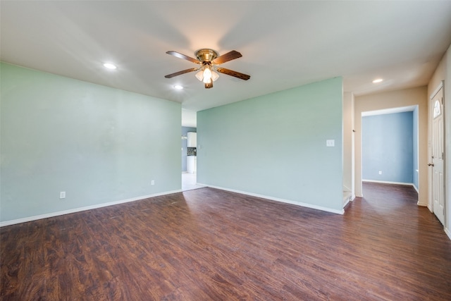 empty room with dark hardwood / wood-style floors and ceiling fan