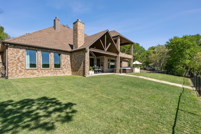 back of property featuring a patio area and a lawn