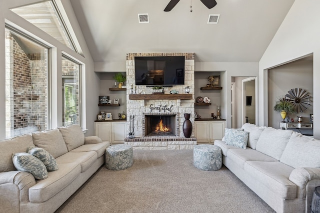 living room featuring a fireplace, carpet floors, ceiling fan, and vaulted ceiling