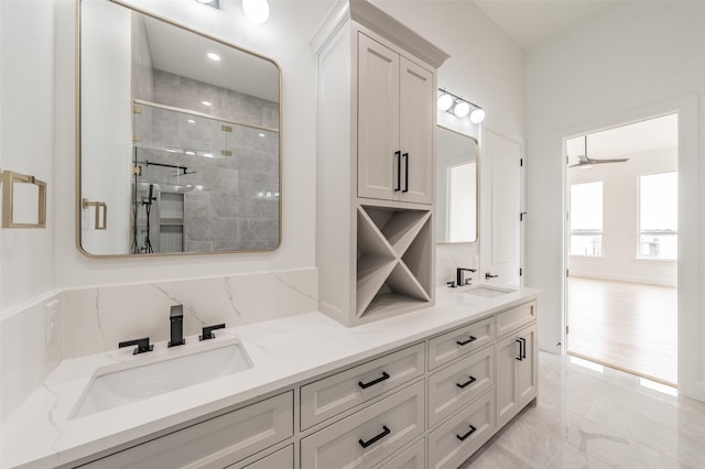 bathroom featuring vanity, ceiling fan, and a shower with door