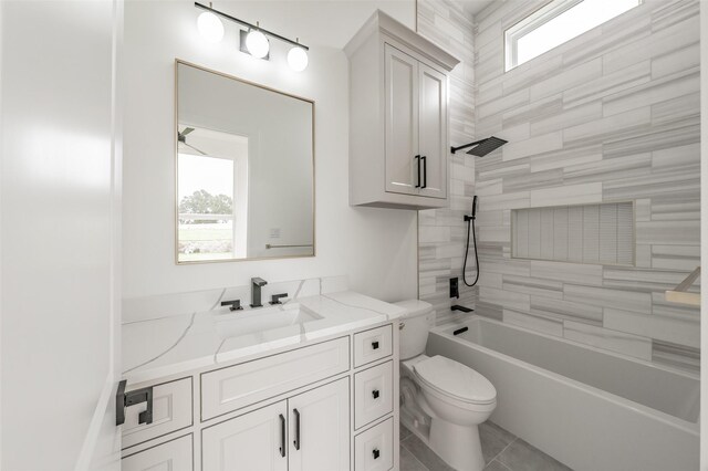 full bathroom with vanity, tiled shower / bath combo, and toilet