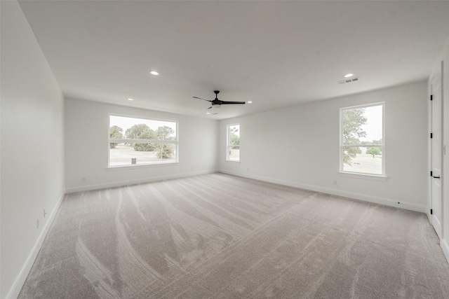 unfurnished room with ceiling fan and light carpet