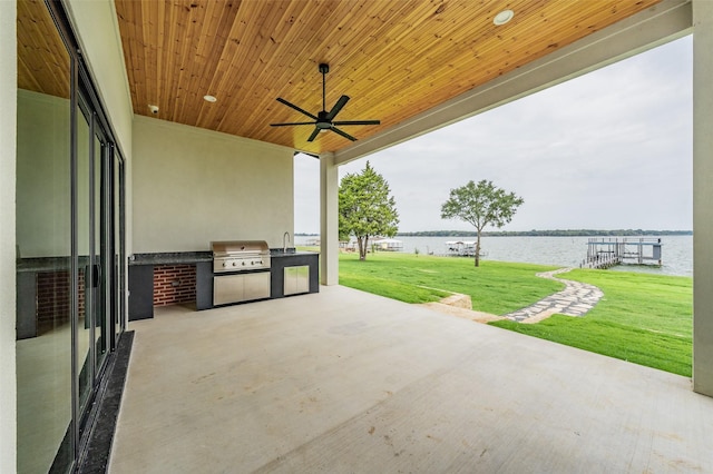 view of patio with area for grilling, ceiling fan, sink, a water view, and a grill