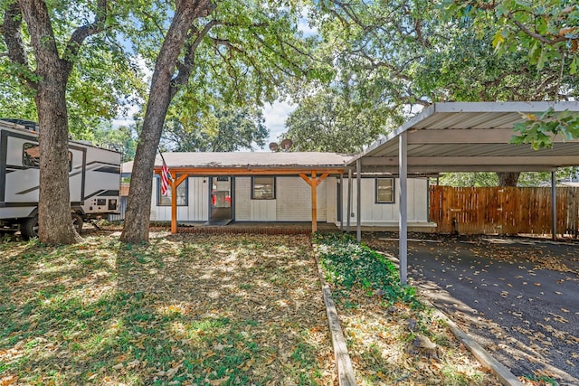 view of front of home with a porch and a carport