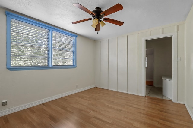 unfurnished bedroom featuring light hardwood / wood-style floors, a textured ceiling, and ceiling fan