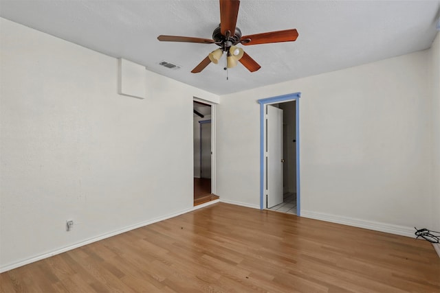 spare room with light hardwood / wood-style flooring and ceiling fan