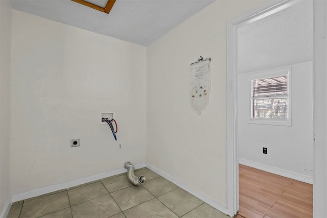 laundry area with hookup for a washing machine, light hardwood / wood-style floors, and hookup for an electric dryer