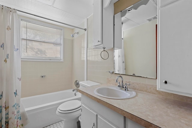 full bathroom featuring tile patterned floors, toilet, shower / bath combo with shower curtain, vanity, and tasteful backsplash