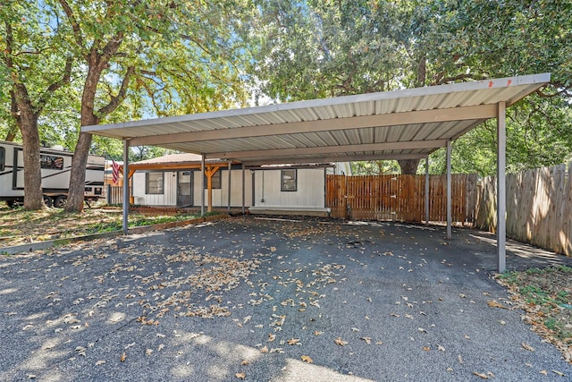 view of parking / parking lot featuring a carport