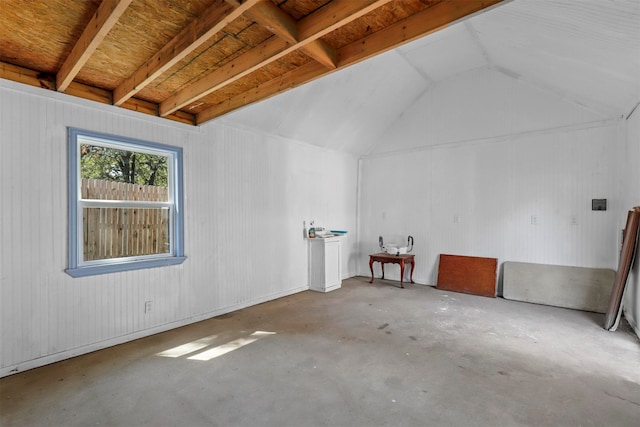 interior space featuring lofted ceiling and concrete flooring