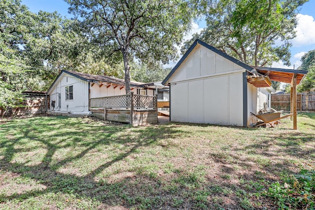 view of yard featuring a wooden deck and a storage unit