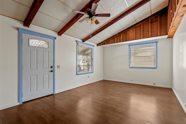 foyer entrance with vaulted ceiling with beams, plenty of natural light, and hardwood / wood-style floors